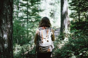 Woman on Hike through Trees