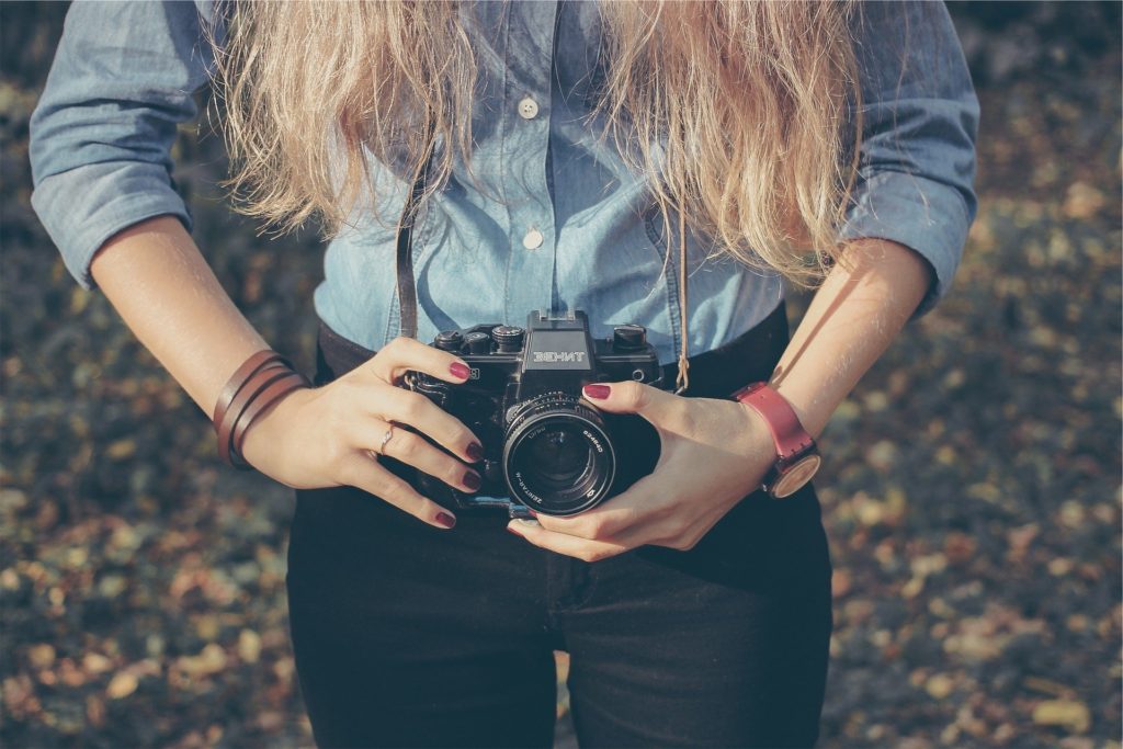 Woman with photo camera at waist