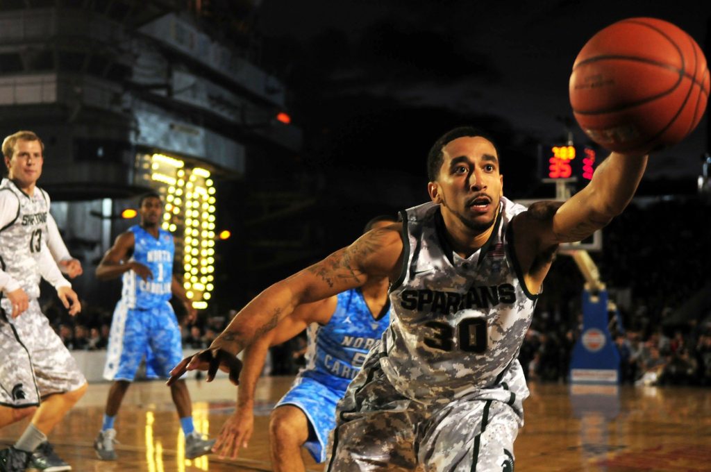 Basketball player reaching for ball