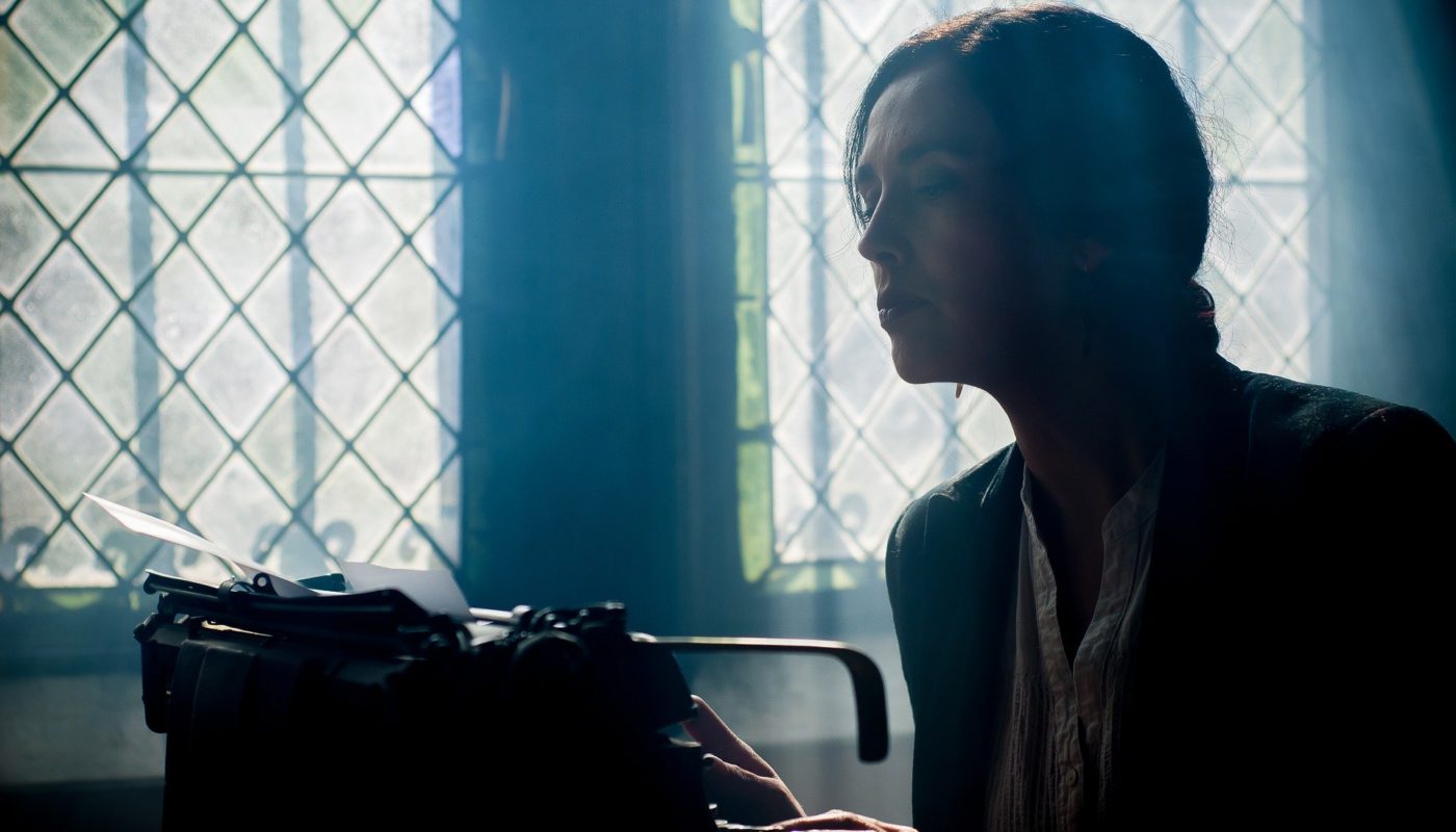 Woman Writing on Typewriter