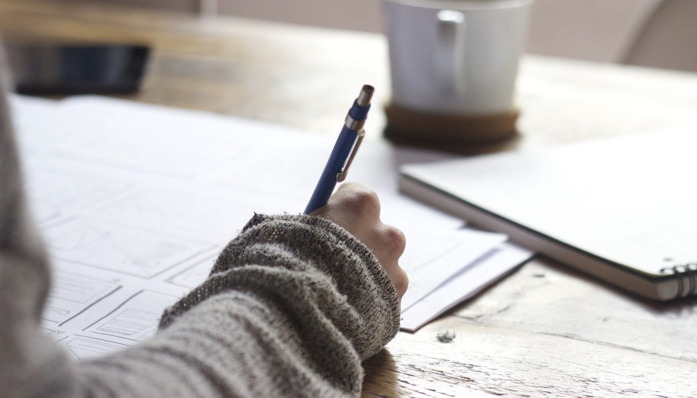 Woman writing with coffee