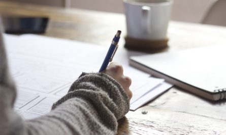 Woman writing with coffee