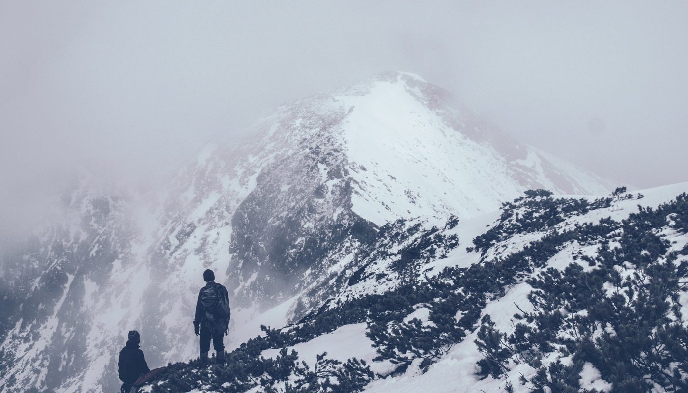 Two people on cold, snowy mountain