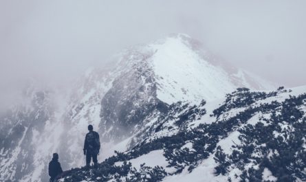 Two people on cold, snowy mountain