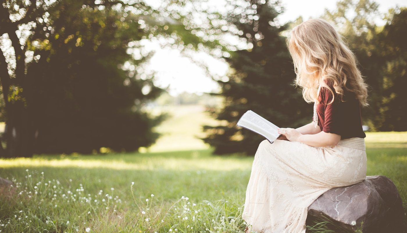 Girl reading in meadow
